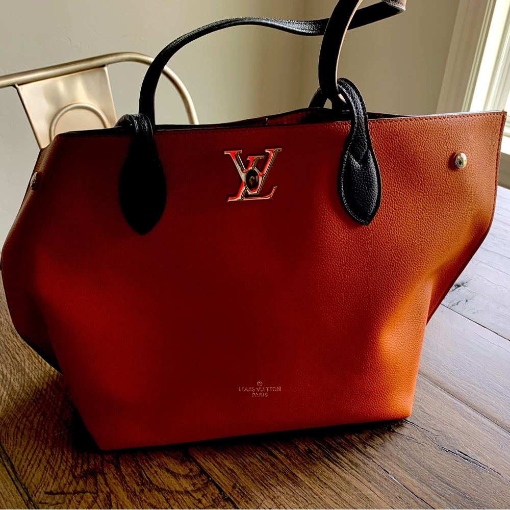 Louis Vuitton brown with black handles leather bag, never used